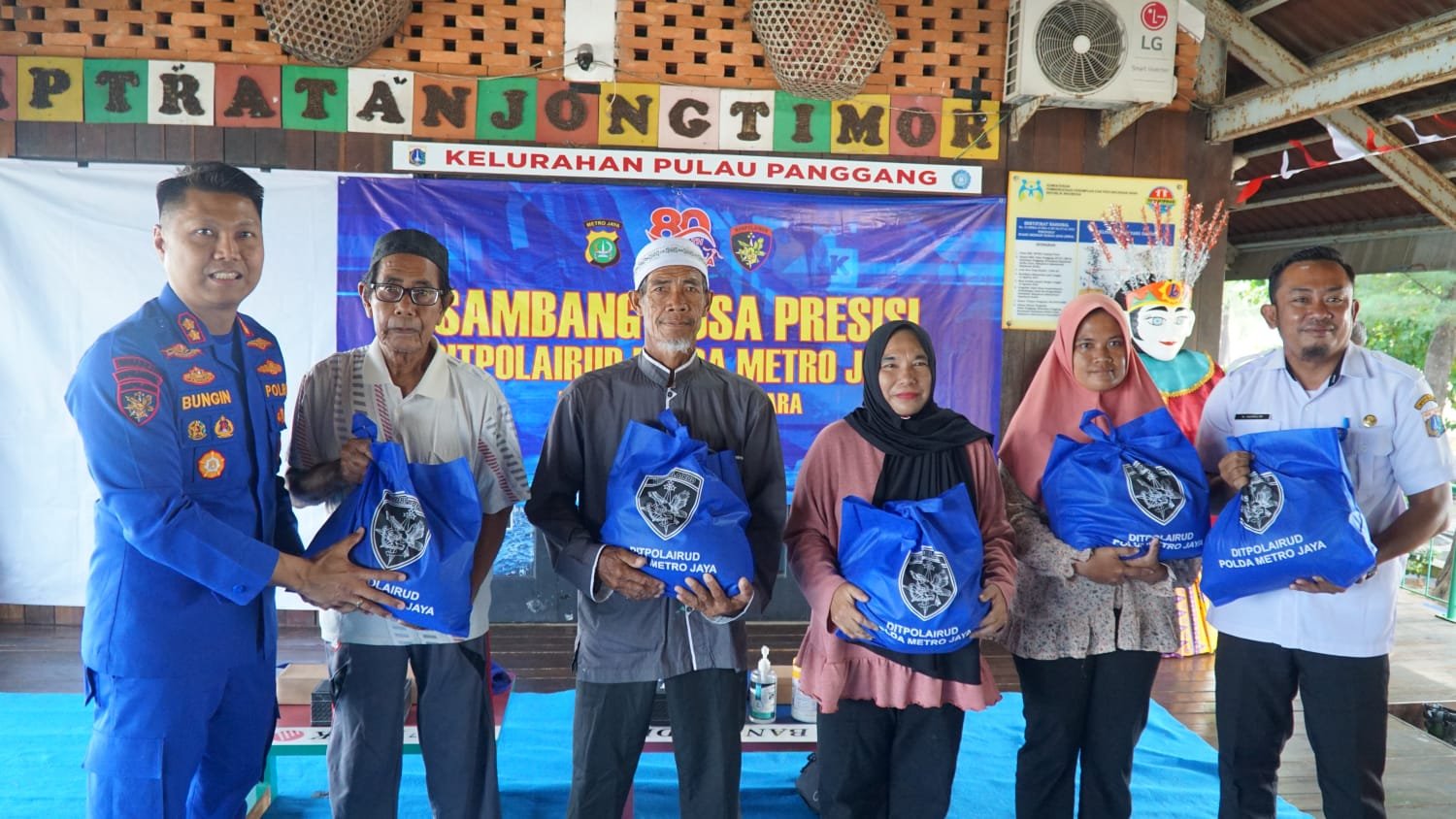 Petugas Polairud menyerahkan bantuan sembako dan sarana ibadah kepada masyarakat Pulau Panggang.